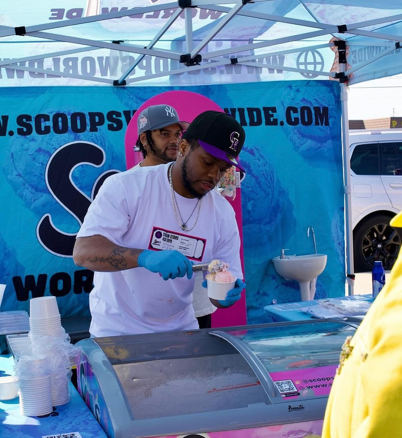 Scoops team member preparing an ice cream cup