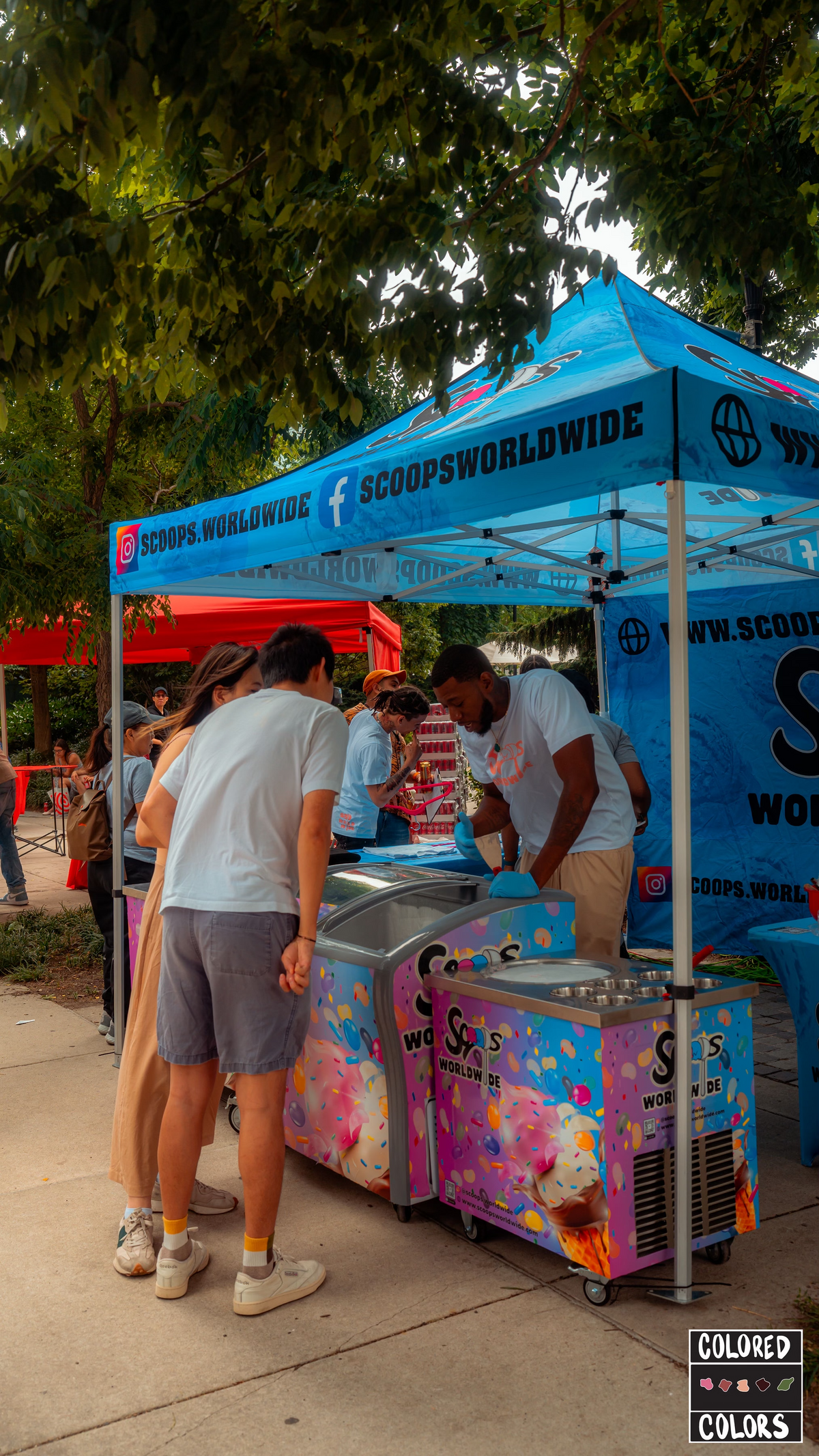 Scoops Worldwide team serving guests at an outdoor pop-up